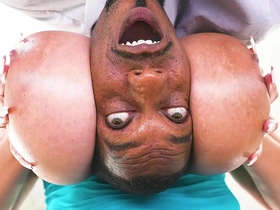 A voluptuous ebony woman with large breasts gives a blowjob to a well-endowed stranger